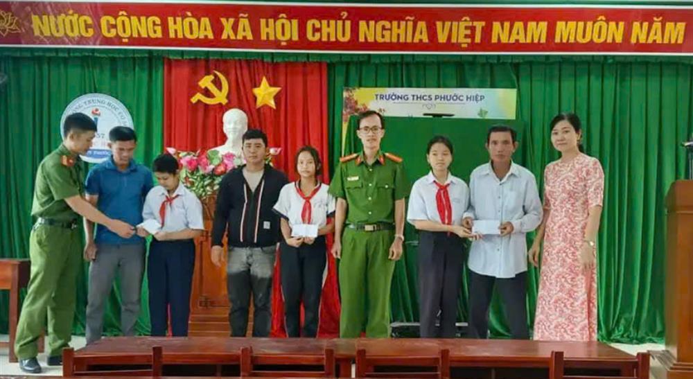 Thiếu tá Nguyễn Vũ Long trao tặng 03 phần quà động viên 3 em học sinh vượt khó học giỏi.