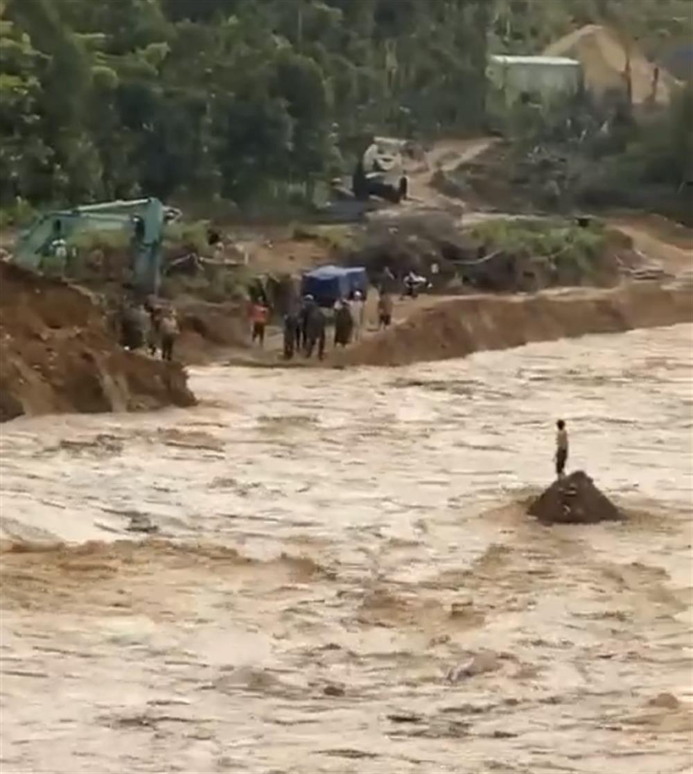 Người dân bị kẹt lại tại một gò đất giữa dòng lũ.