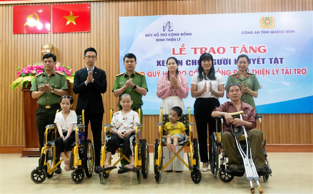 Delegates present wheelchairs to disabled people.